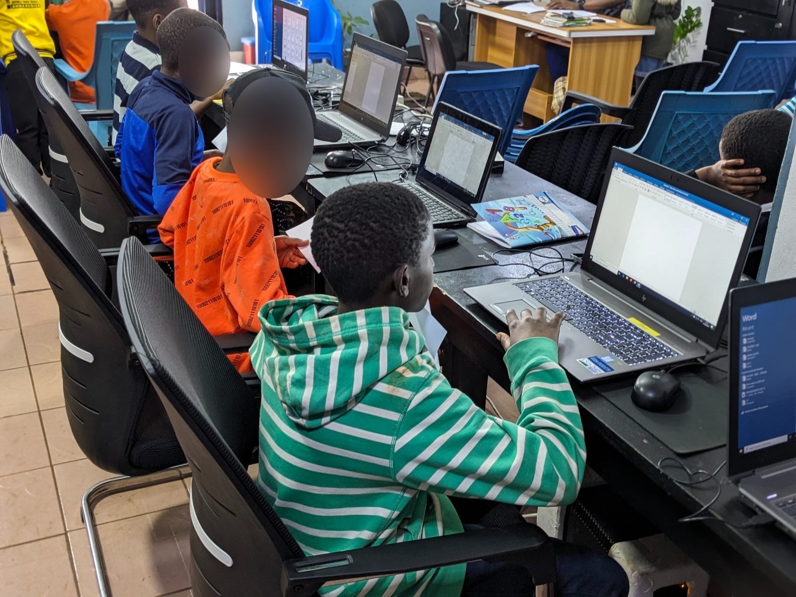 Des participants travaillent sur ordinateur portable pendant la première édition du programme Vacances Créatives, en août 2025